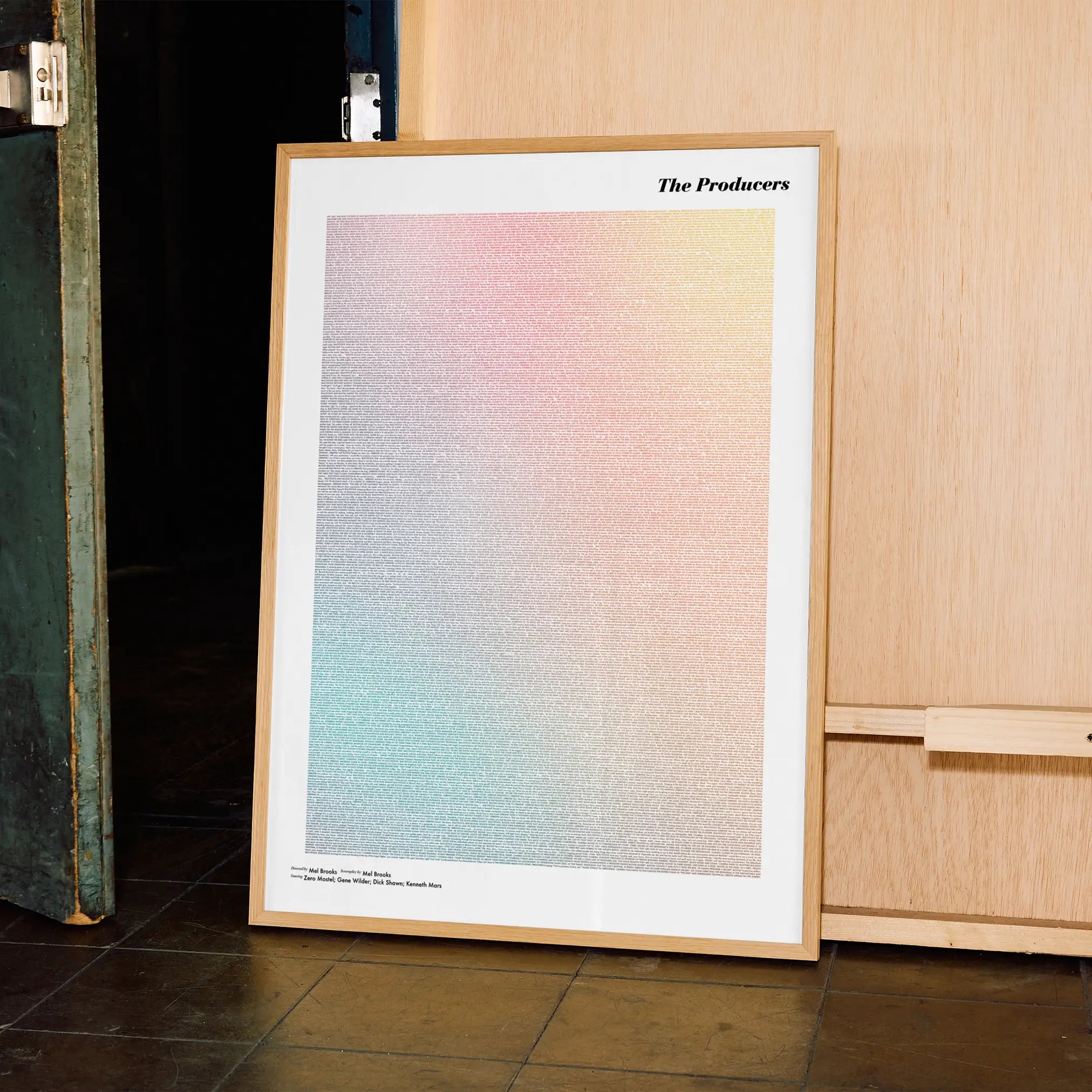 A framed The Producers movie script poster displayed in a contemporary interior setting.