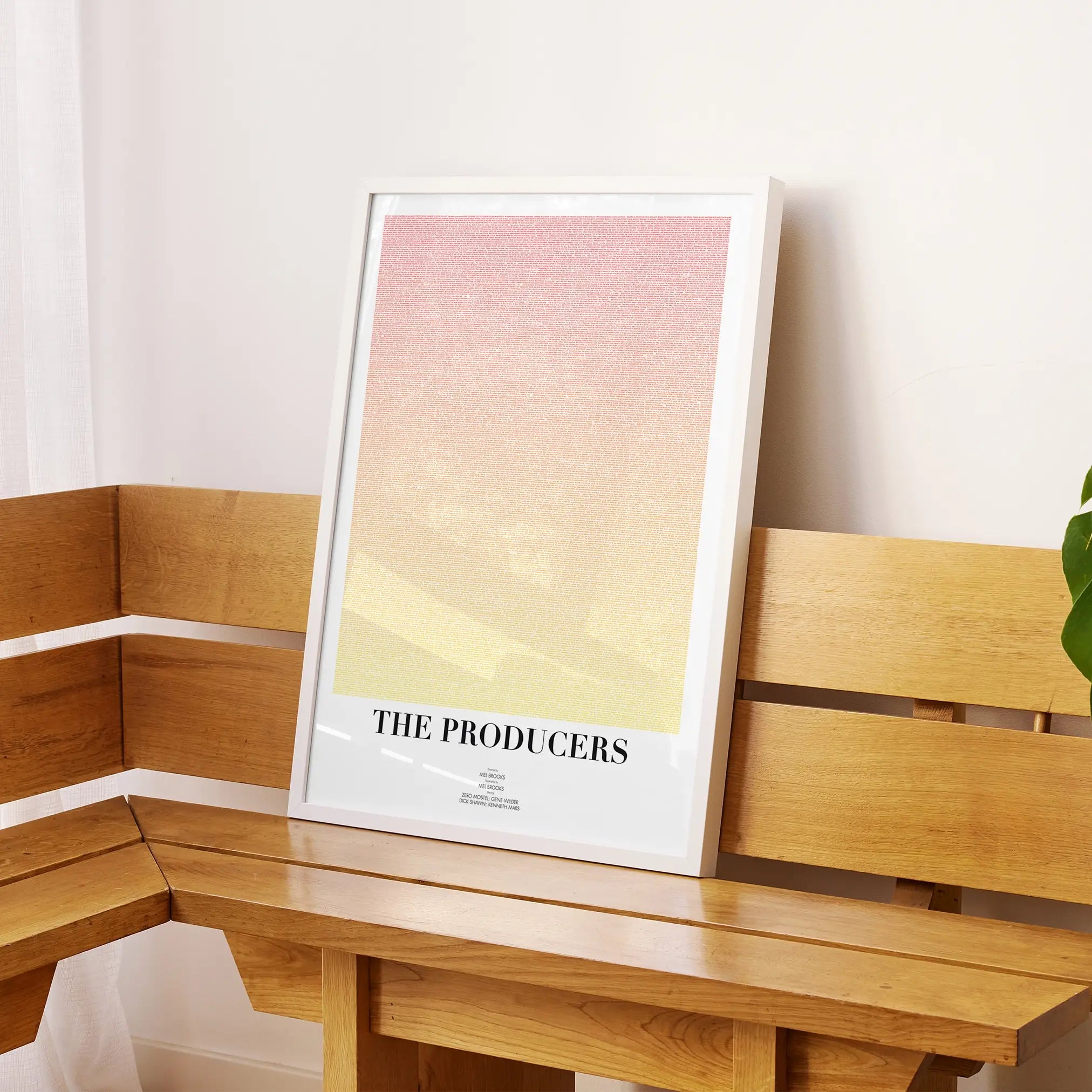 A framed The Producers movie script poster displayed on a sideboard in a contemporary space.
