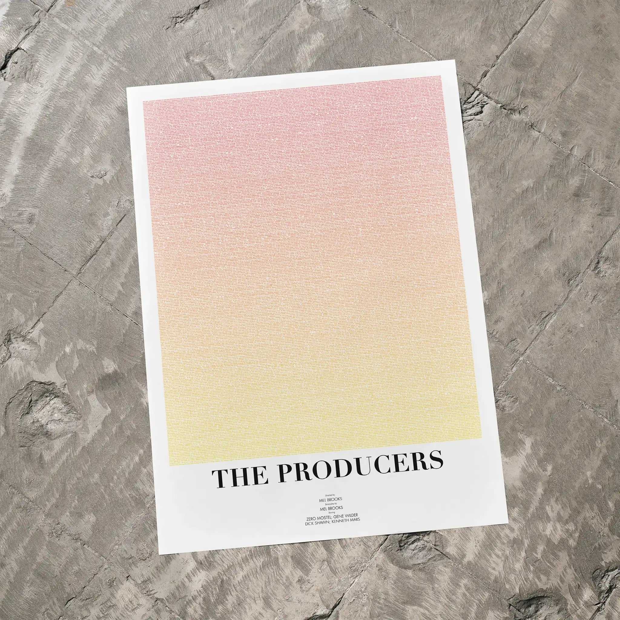 A The Producers movie script poster laid flat on a textured floor surface.