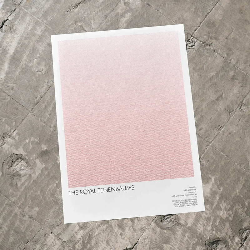 A The Royal Tenenbaums movie script poster laid flat on a textured floor surface.