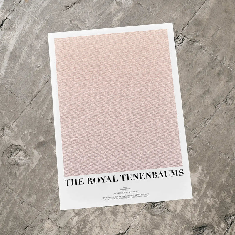 A The Royal Tenenbaums movie script poster laid flat on a textured floor surface.