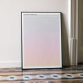 A framed The Royal Tenenbaums movie script poster leaning against a wall in a minimalist interior.