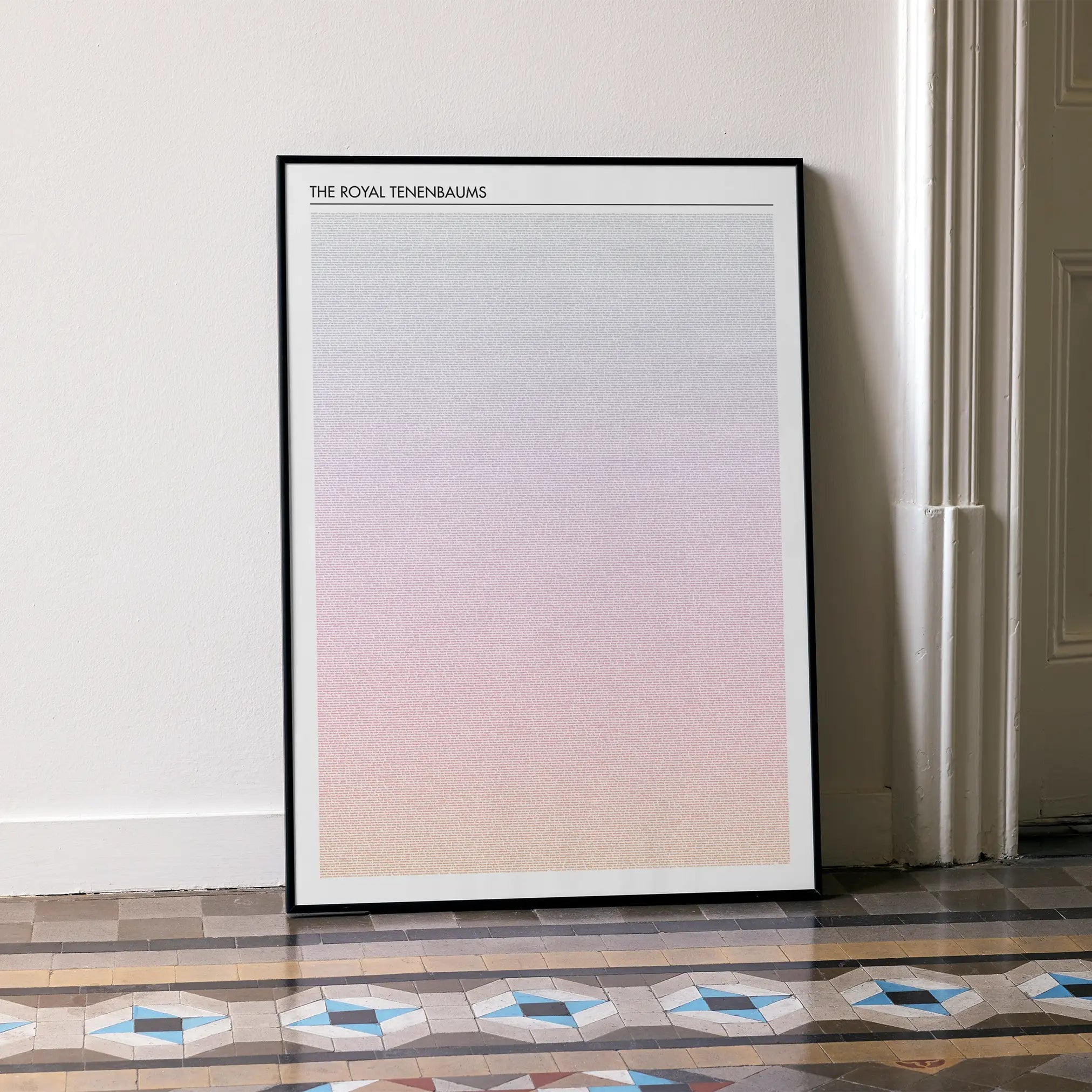 A framed The Royal Tenenbaums movie script poster leaning against a wall in a minimalist interior.