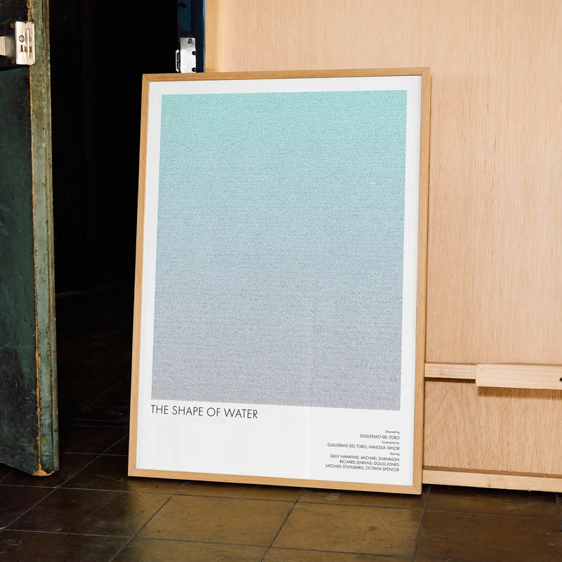 A framed The Shape of Water movie script poster displayed in a contemporary interior setting.