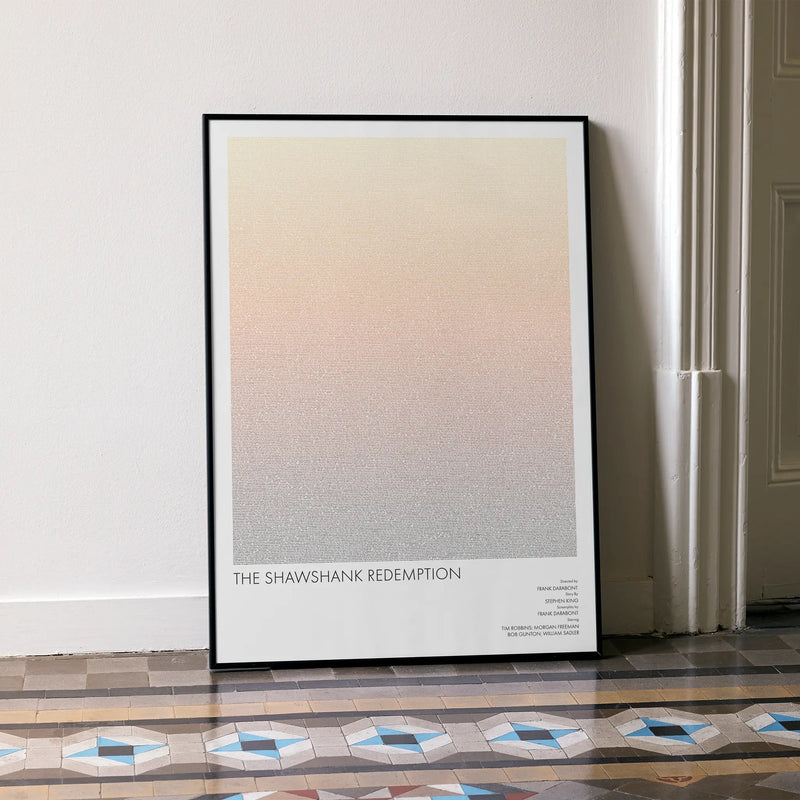 A framed The Shawshank Redemption movie script poster leaning against a wall in a minimalist interior.