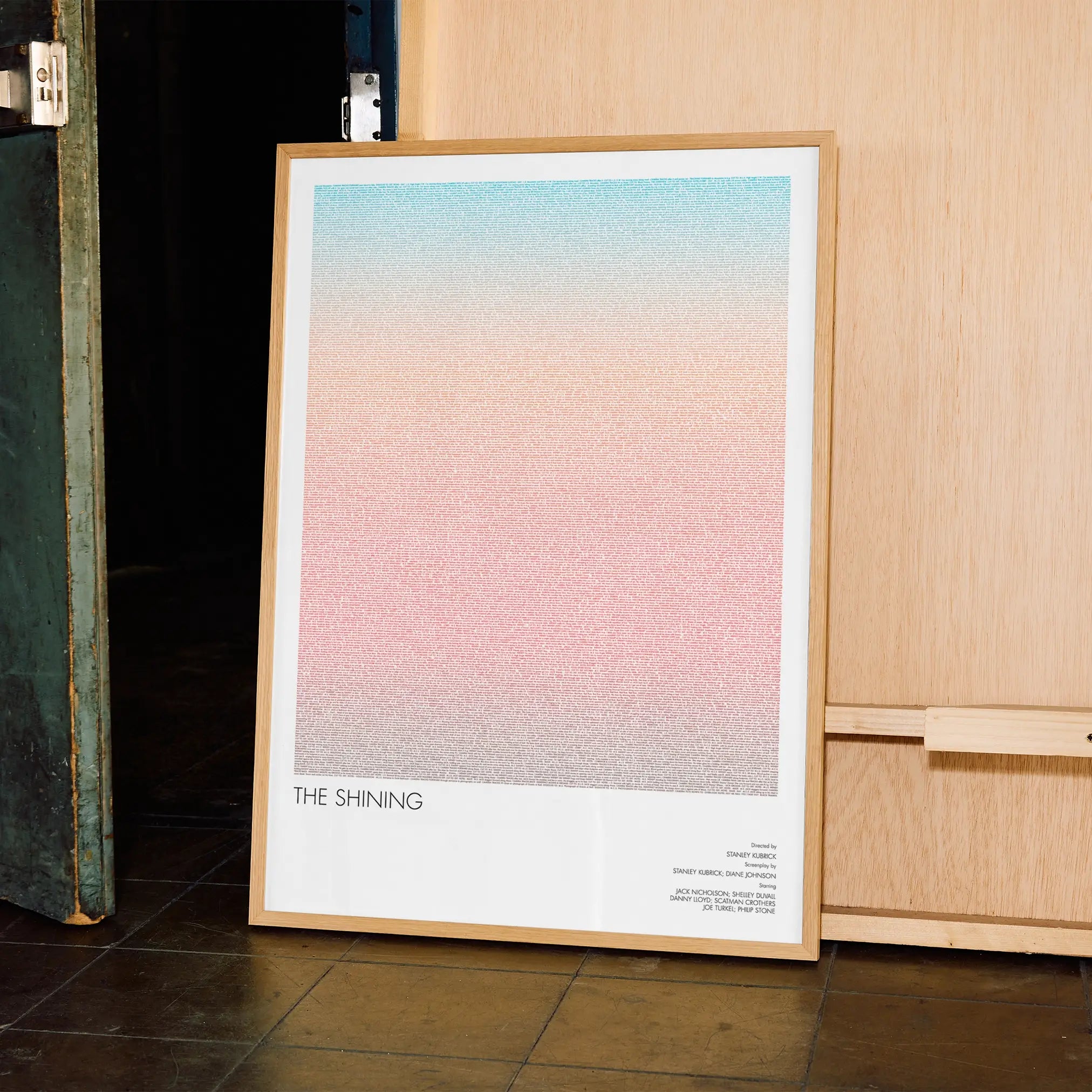 A framed The Shining movie script poster displayed in a contemporary interior setting.