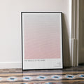 A framed The Silence of the Lambs movie script poster leaning against a wall in a minimalist interior.