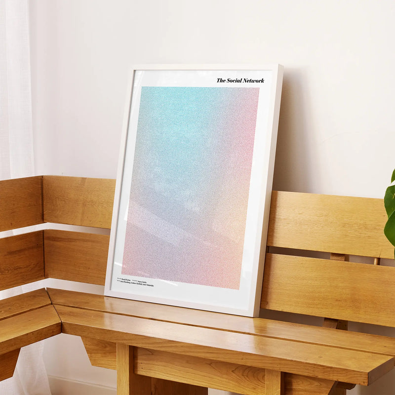 A framed The Social Network movie script poster displayed on a sideboard in a contemporary space.