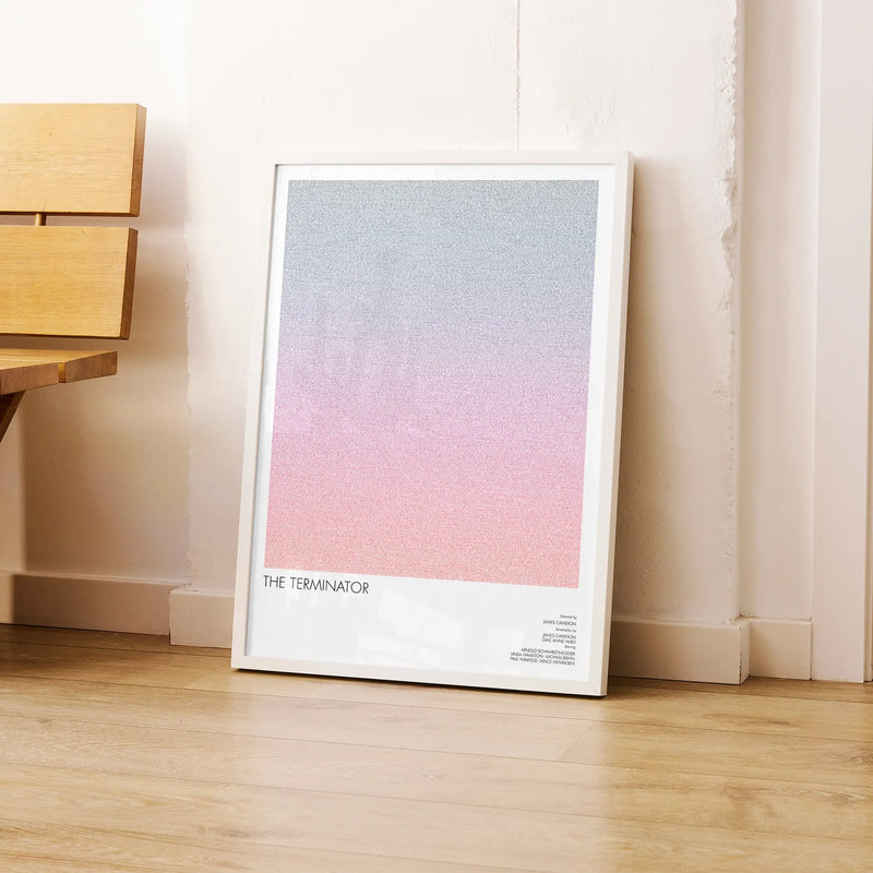 A framed The Terminator movie script poster leaning against a wall in a modern interior.
