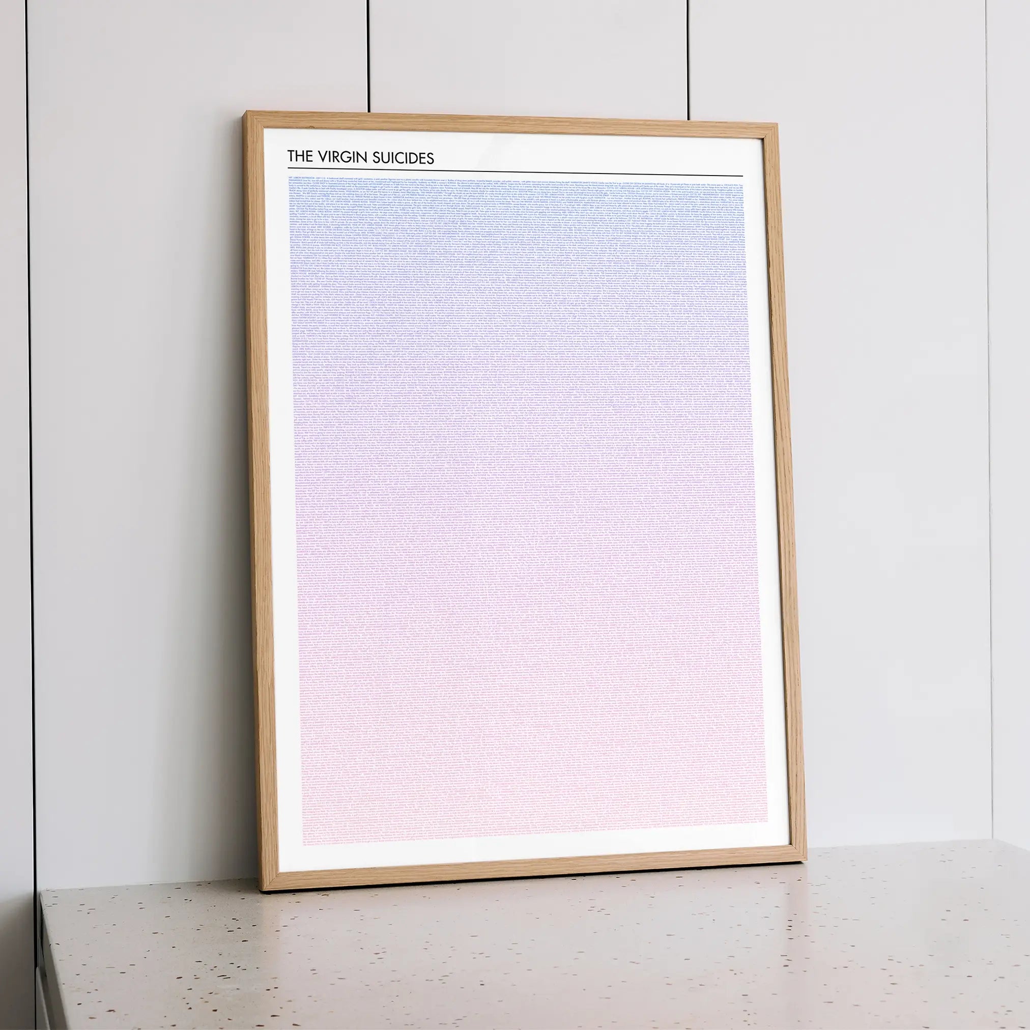 A framed The Virgin Suicides movie script poster styled within a calm interior space.