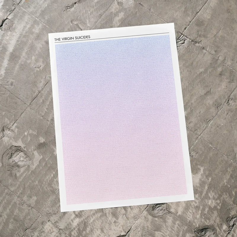 A The Virgin Suicides movie script poster laid flat on a textured floor surface.