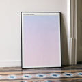 A framed The Virgin Suicides movie script poster leaning against a wall in a minimalist interior.
