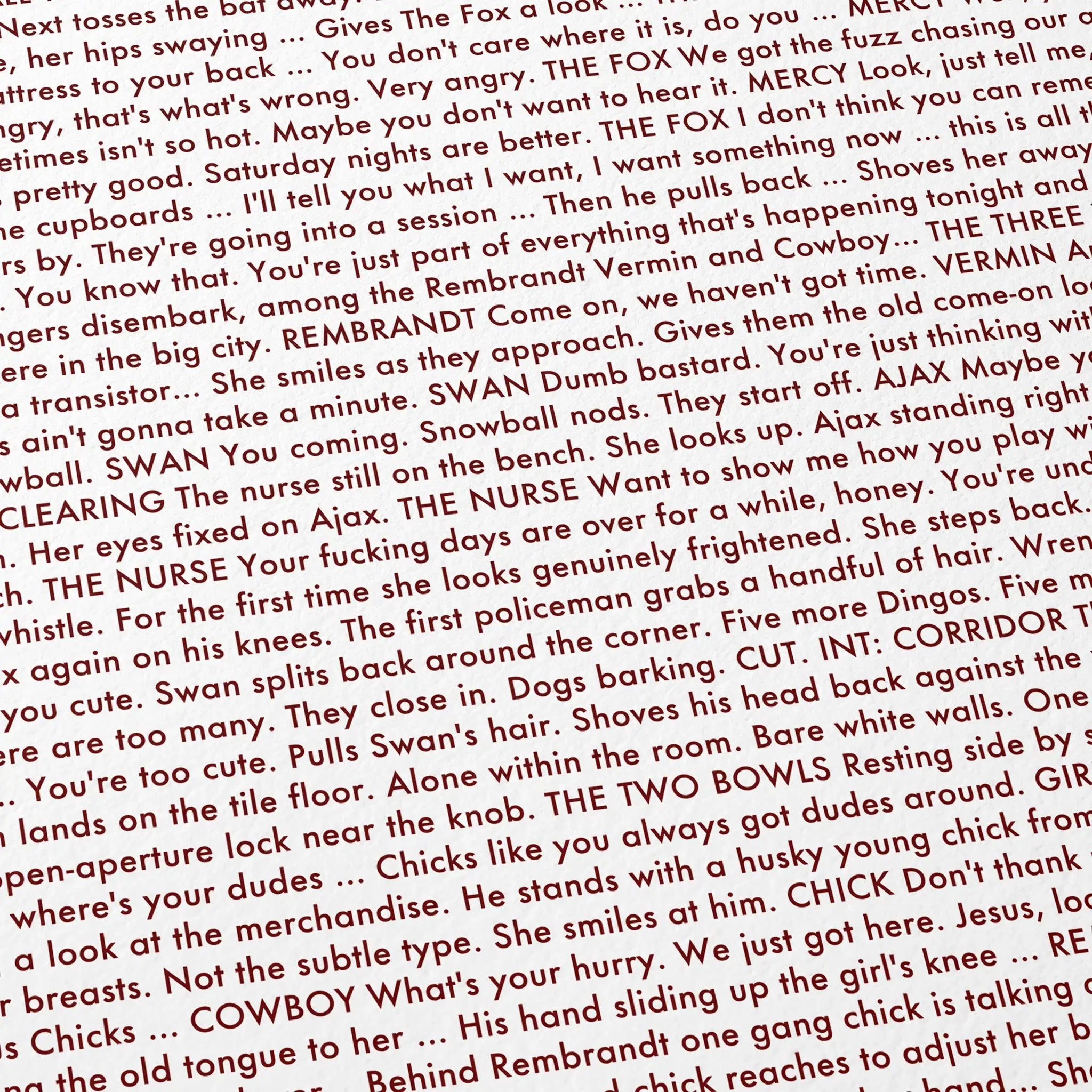 A close-up of printed text from the 1979 The Warriors screenplay, with red and black lettering.