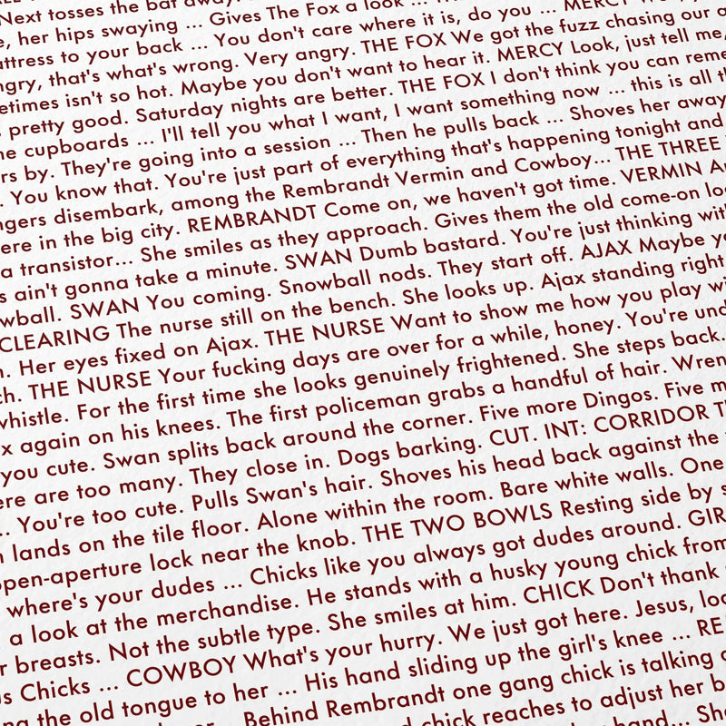 A close-up of printed text from the 1979 The Warriors screenplay, with red and black lettering.