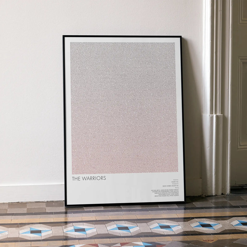 A framed minimalist The Warriors movie art print leaning against a white wall on a patterned tiled floor. 'THE WARRIORS' near the bottom.