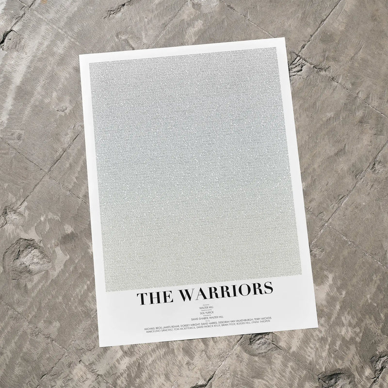 A minimalist art print titled 'THE WARRIORS' featuring a large textured light gray square on a white border, photographed flat on a gray stone surface.