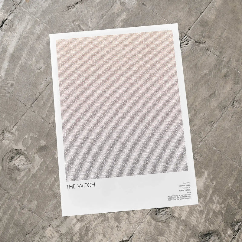 A The Witch movie script poster laid flat on a textured floor surface.