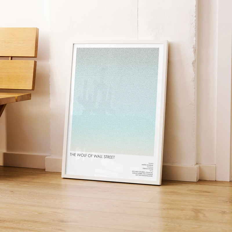 A framed The Wolf of Wall Street movie script poster leaning against a wall in a modern interior.