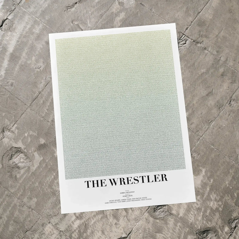 A The Wrestler movie script poster laid flat on a textured floor surface.
