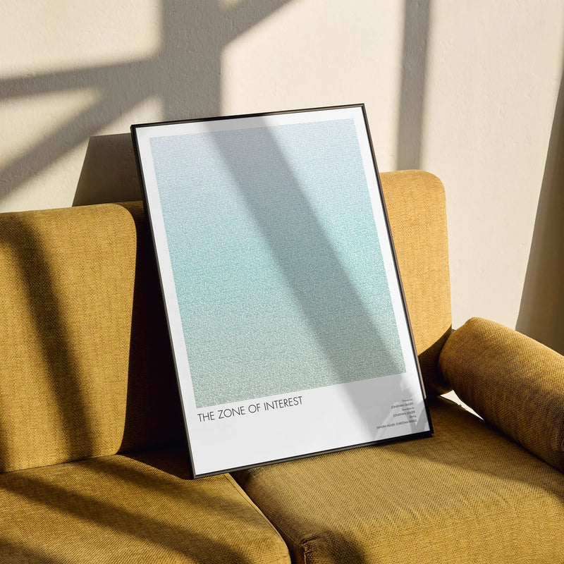A framed The Zone of Interest movie script poster styled in a clean interior setting.