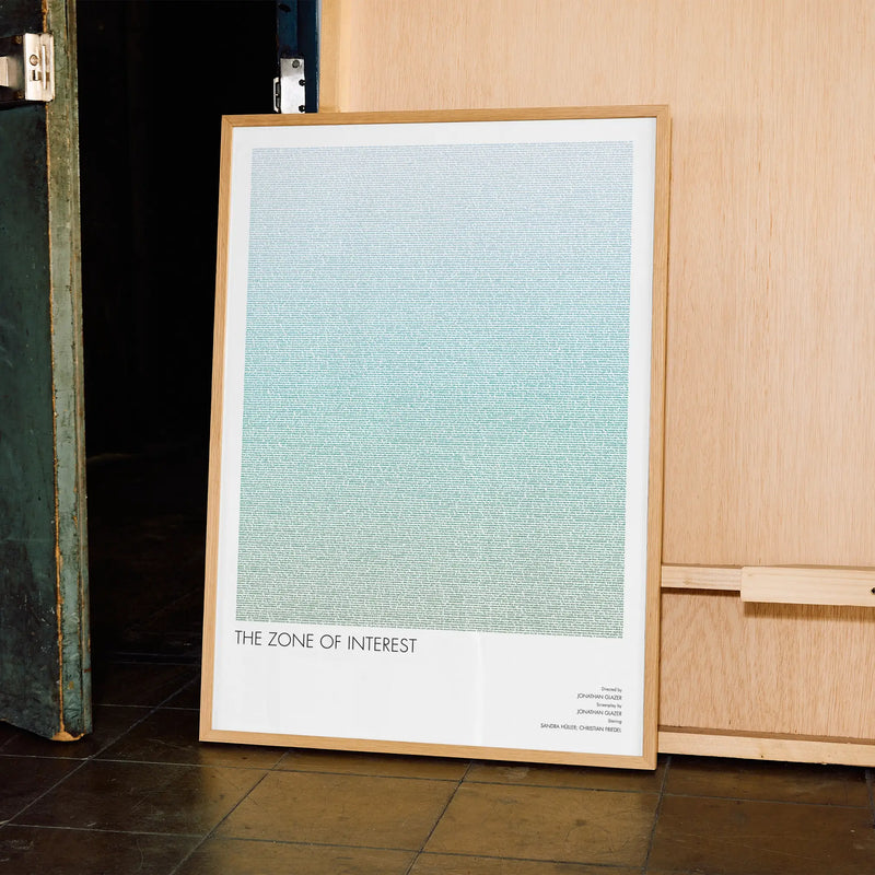 A framed The Zone of Interest movie script poster displayed in a contemporary interior setting.