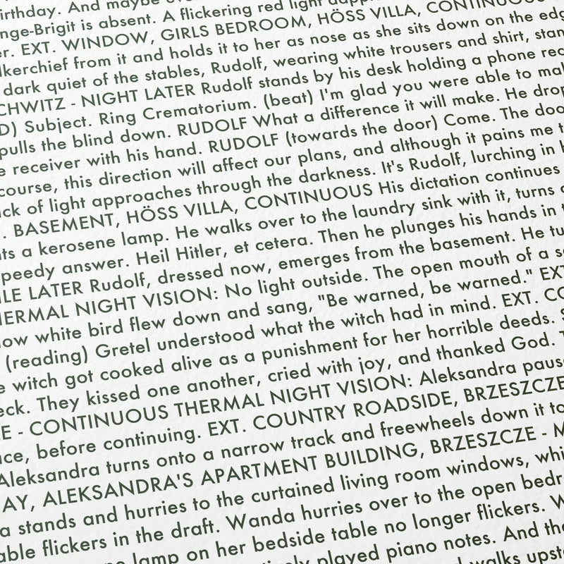 Close-up detail of the The Zone of Interest movie script poster showing dense typographic text.
