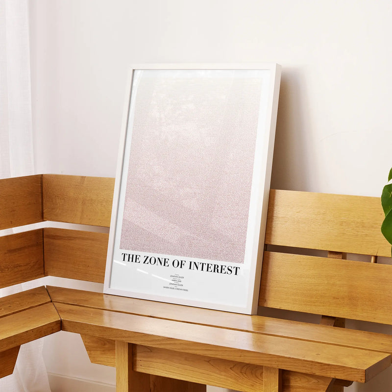 A framed The Zone of Interest movie script poster displayed on a sideboard in a contemporary space.