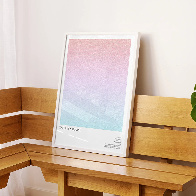 A framed Thelma & Louise movie script poster displayed on a sideboard in a contemporary space.