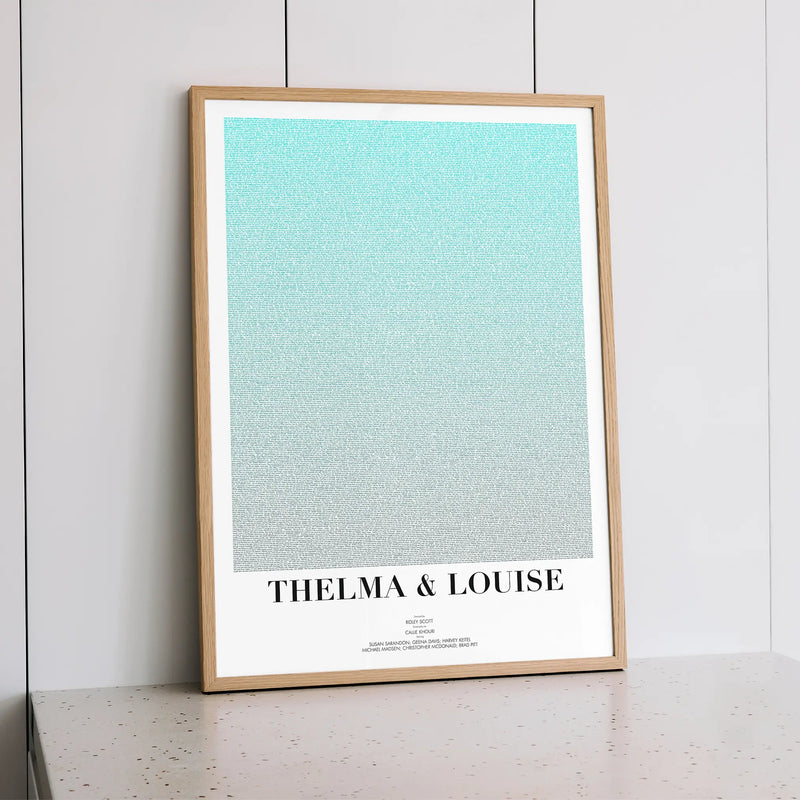 A framed Thelma & Louise movie script poster styled within a calm interior space.