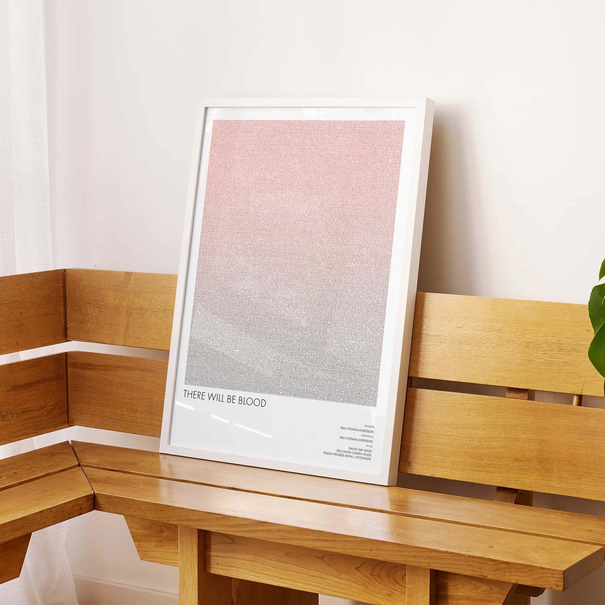 A framed There Will Be Blood movie script poster displayed on a sideboard in a contemporary space.