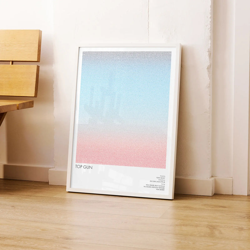 A framed Top Gun movie script poster leaning against a wall in a modern interior.