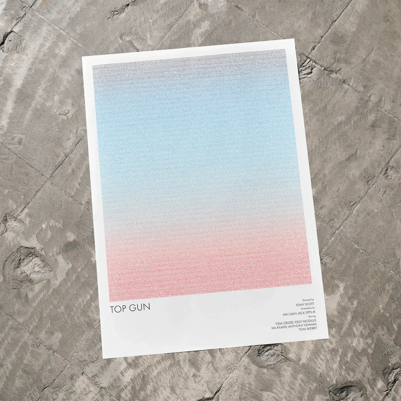 A Top Gun movie script poster laid flat on a textured floor surface.