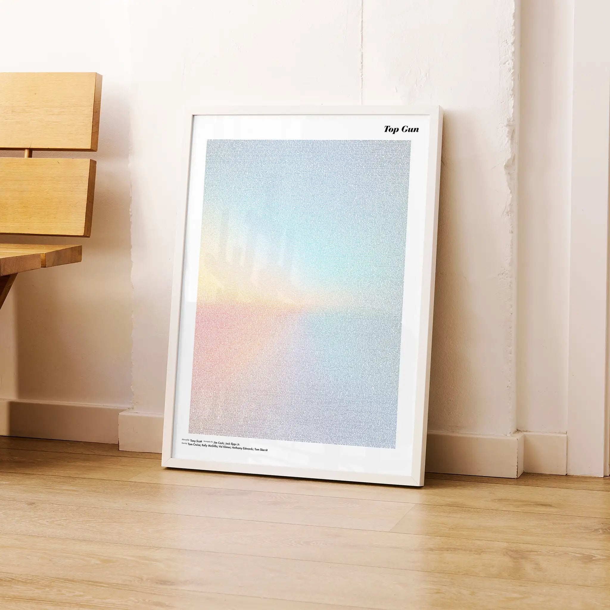 Framed Top Gun artwork with a gradient design on a wooden floor.