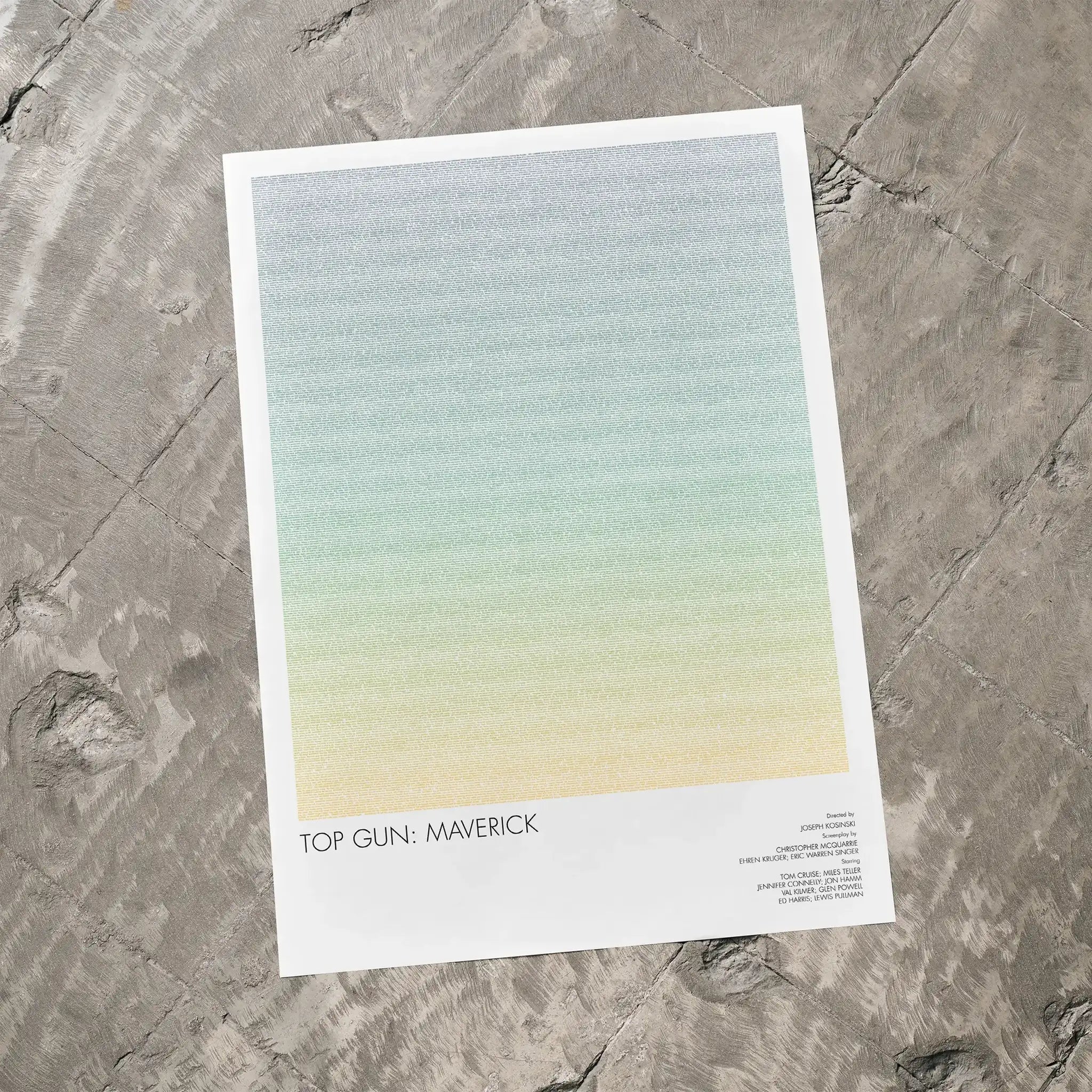 A Top Gun: Maverick movie script poster laid flat on a textured floor surface.