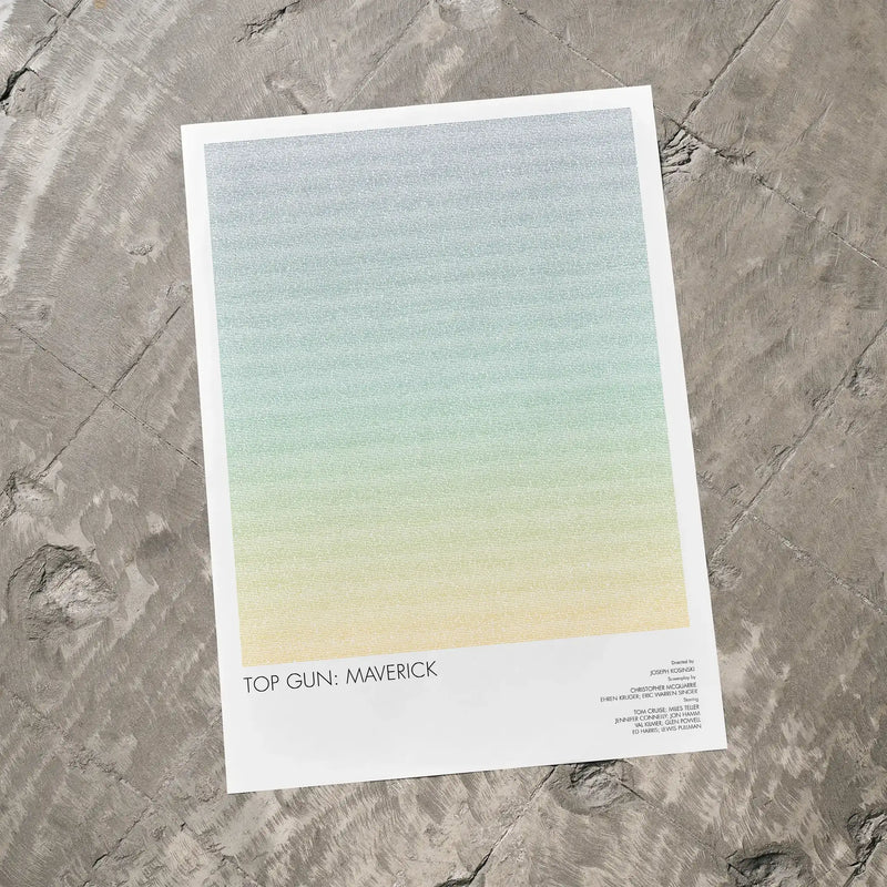A Top Gun: Maverick movie script poster laid flat on a textured floor surface.