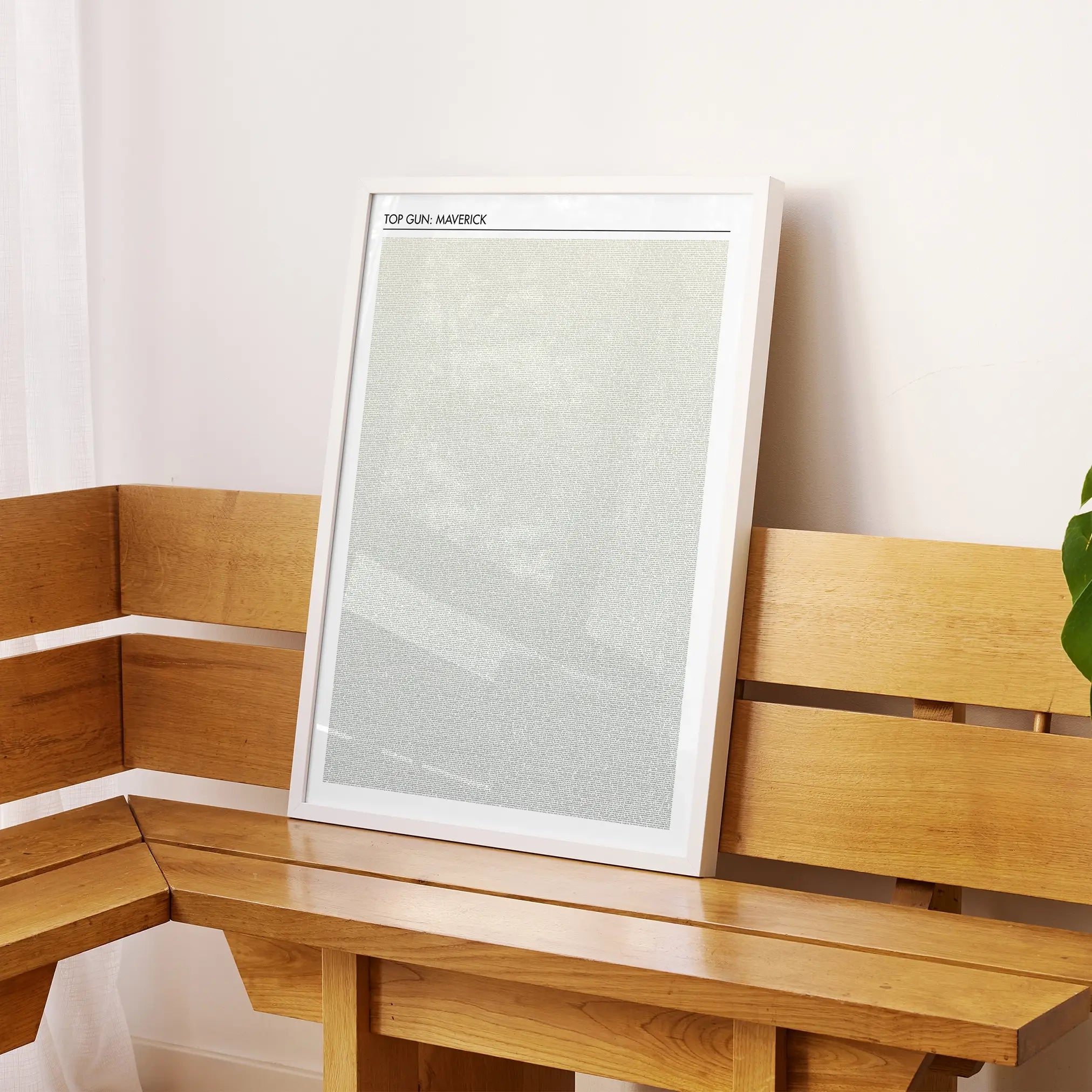 A framed Top Gun: Maverick movie script poster displayed on a sideboard in a contemporary space.