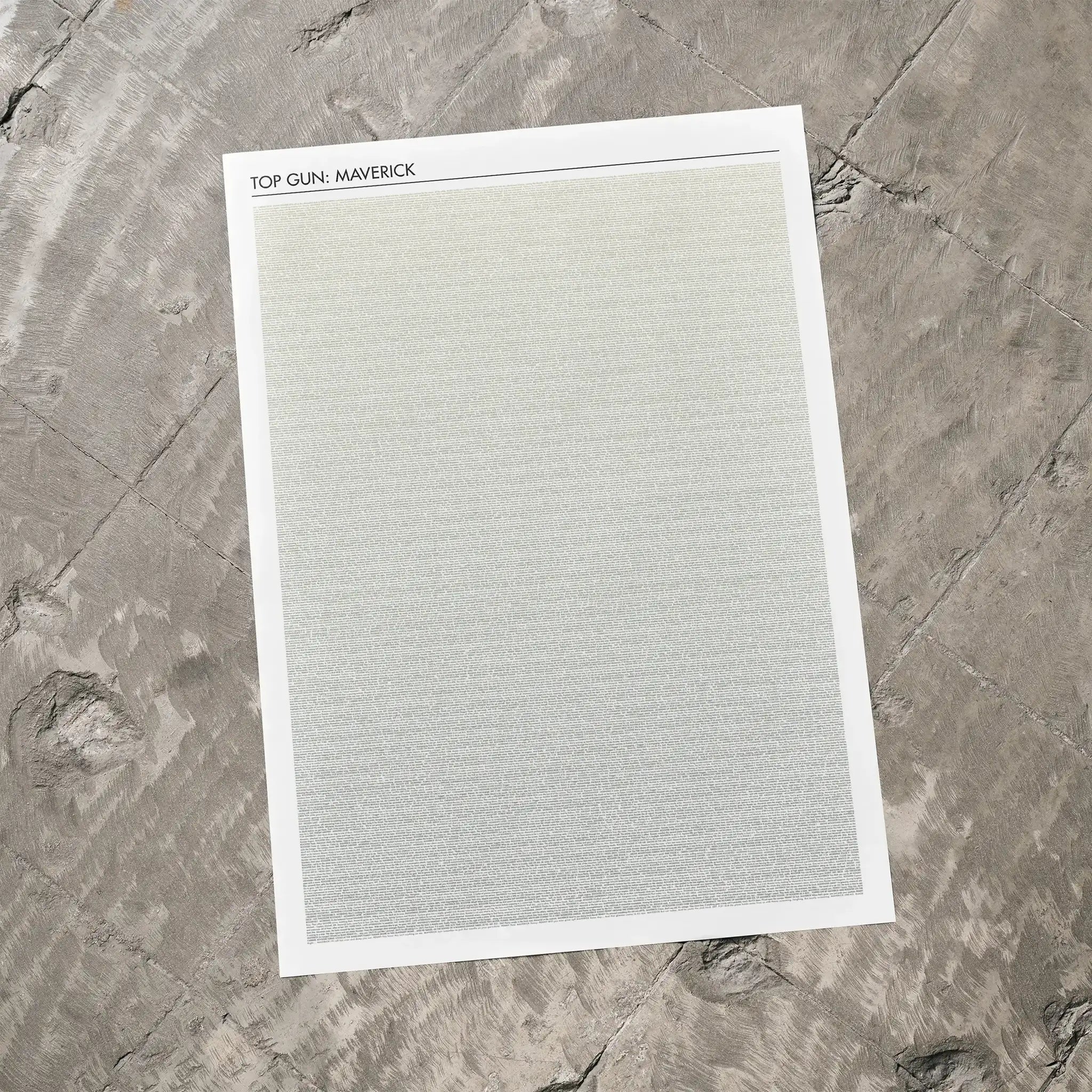 A Top Gun: Maverick movie script poster laid flat on a textured floor surface.