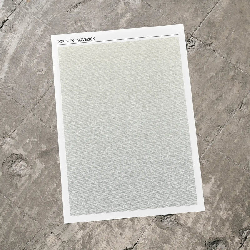 A Top Gun: Maverick movie script poster laid flat on a textured floor surface.
