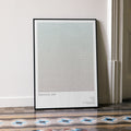A framed Training Day movie script poster leaning against a wall in a minimalist interior.