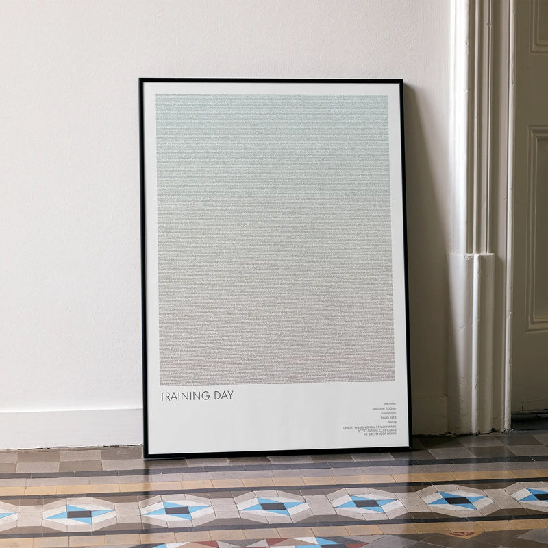 A framed Training Day movie script poster leaning against a wall in a minimalist interior.