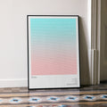 A framed Tron movie script poster leaning against a wall in a minimalist interior.