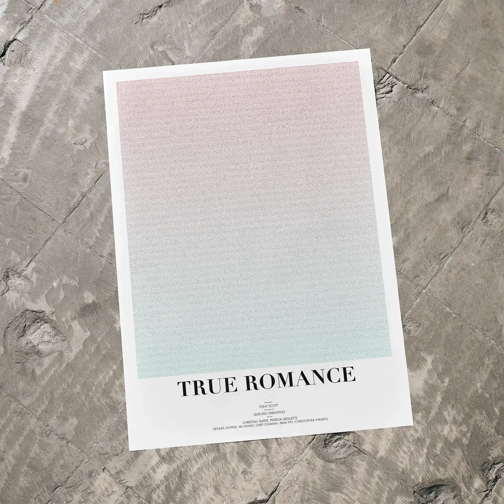 A True Romance movie script poster laid flat on a textured floor surface.