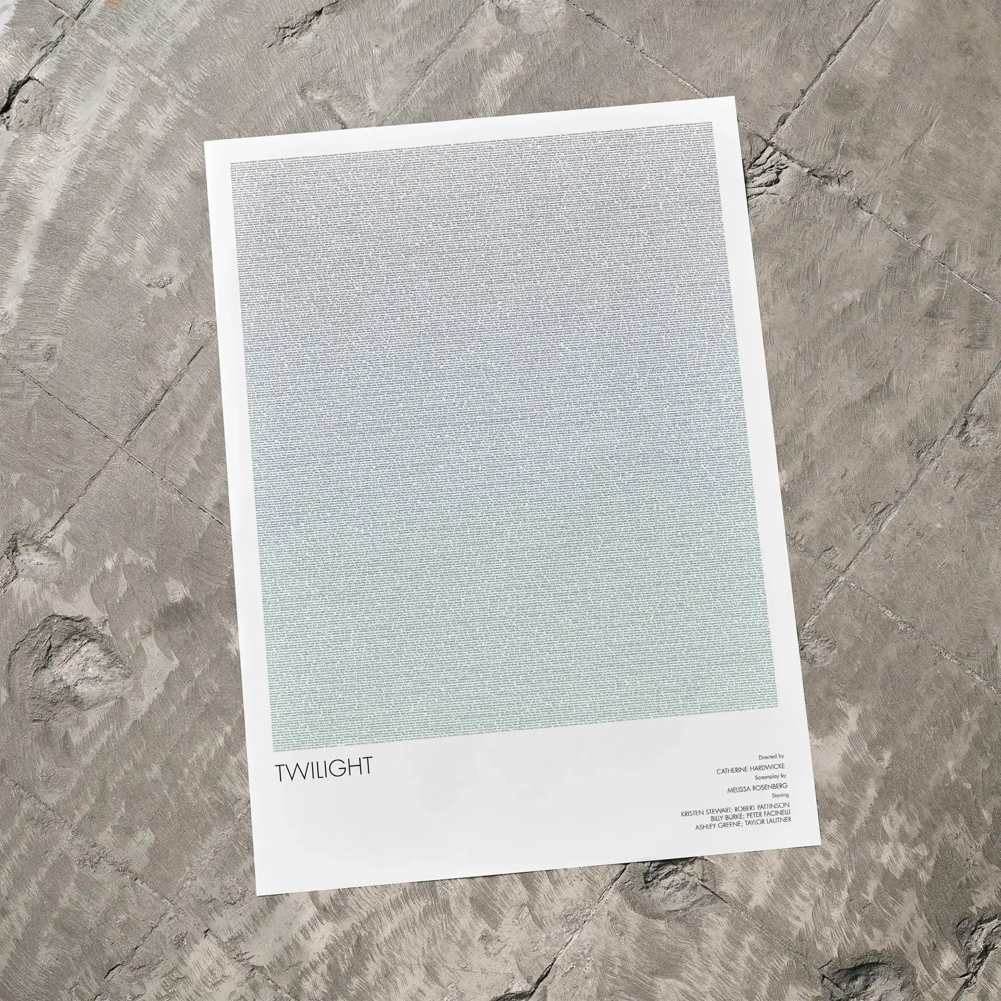 A Twilight movie script poster laid flat on a textured floor surface.