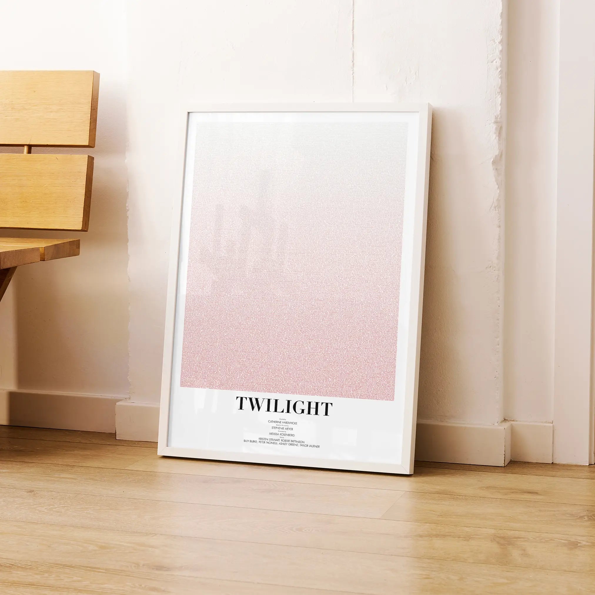 A framed Twilight movie script poster leaning against a wall in a modern interior.