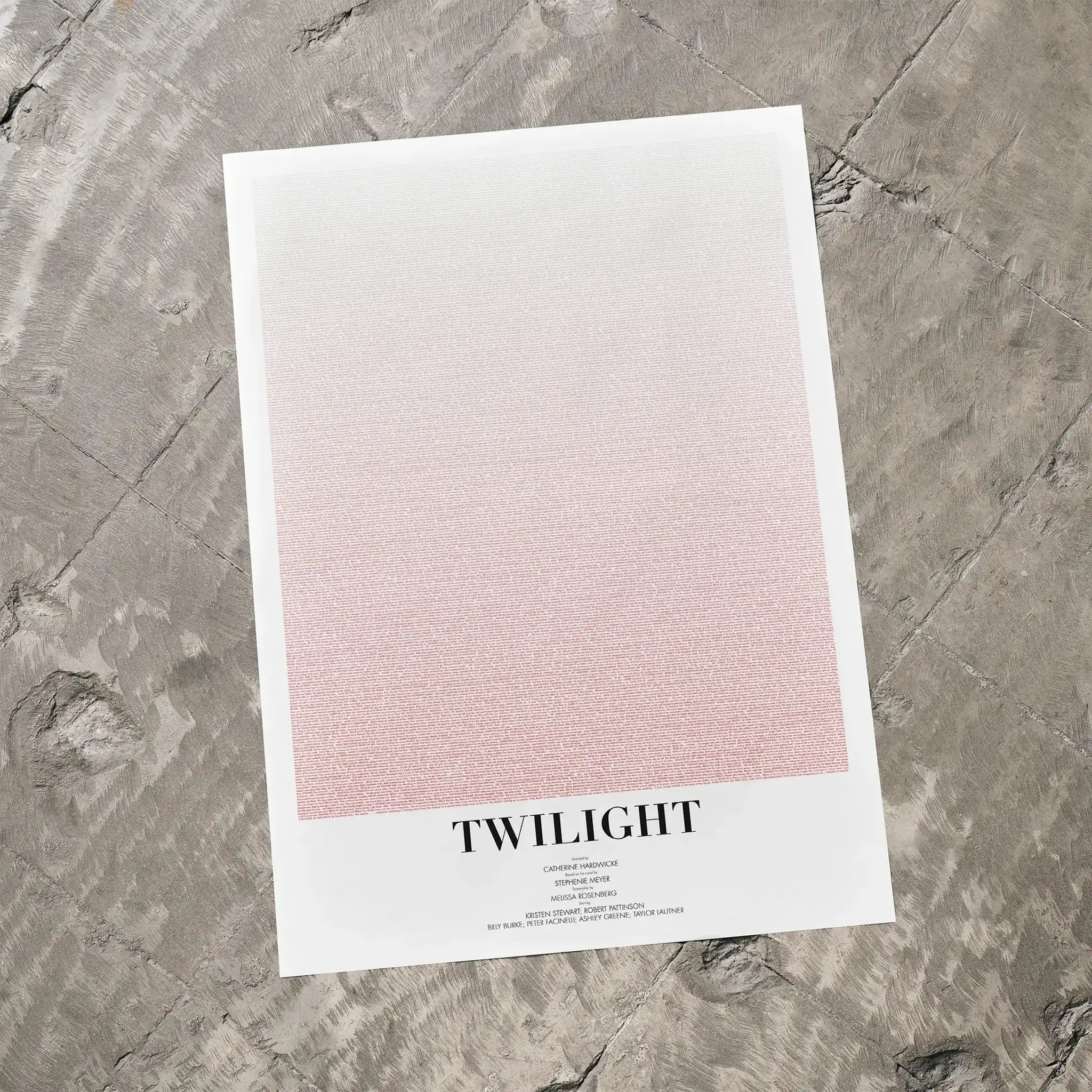 A Twilight movie script poster laid flat on a textured floor surface.