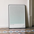 A framed Uncut Gems movie script poster leaning against a wall in a minimalist interior.