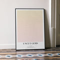 A framed Uncut Gems movie script poster leaning against a wall in a minimalist interior.
