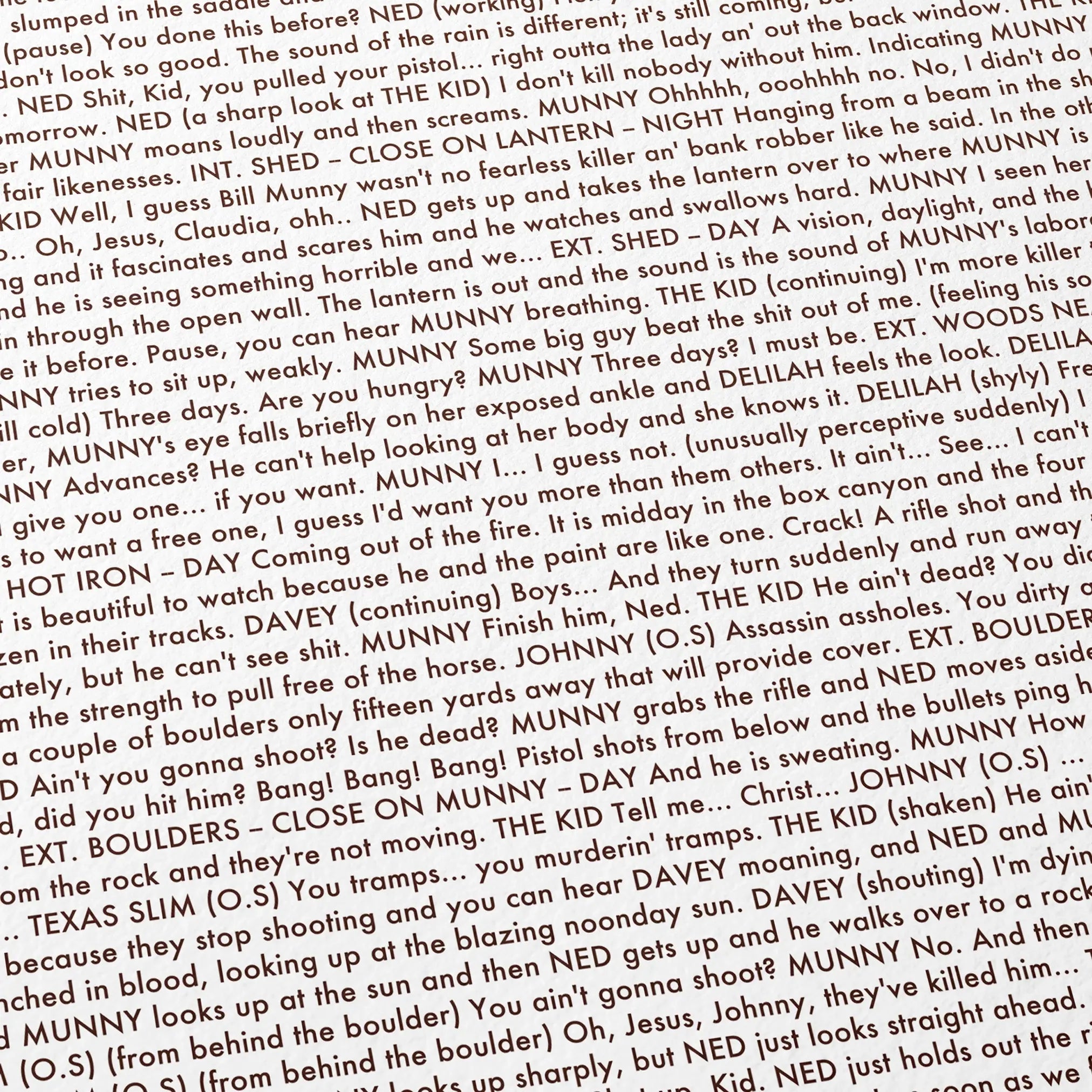 Close-up detail of the Unforgiven movie script poster showing dense typographic text.