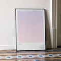 A framed WALL·E movie script poster leaning against a wall in a minimalist interior.
