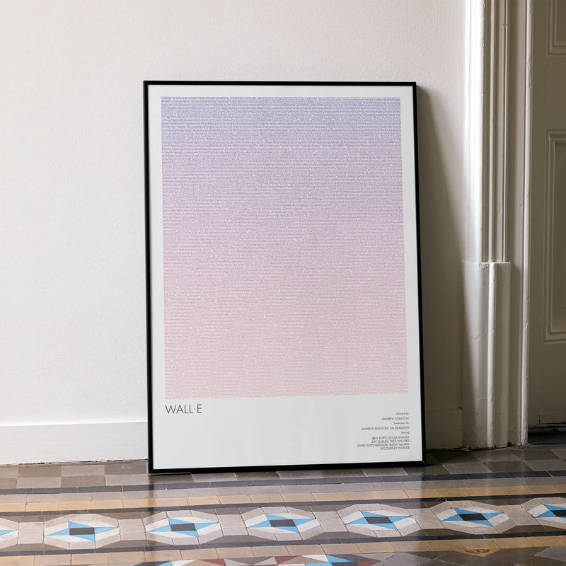 A framed WALL·E movie script poster leaning against a wall in a minimalist interior.